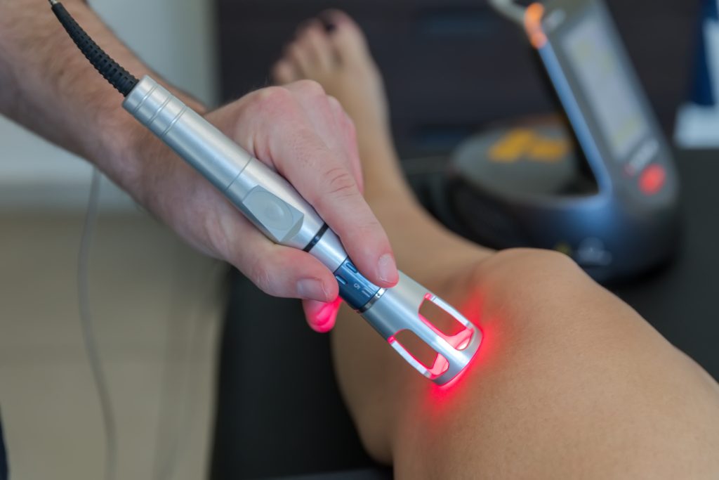 Laser therapy on knee for the treatment of knee pain.