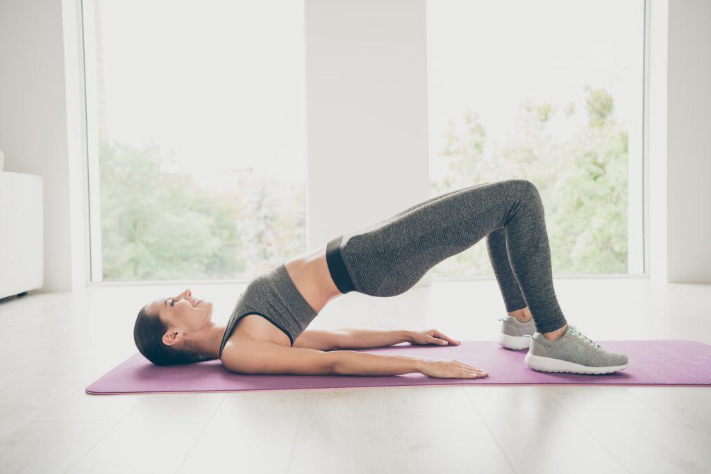 Woman doing bridging exercise.