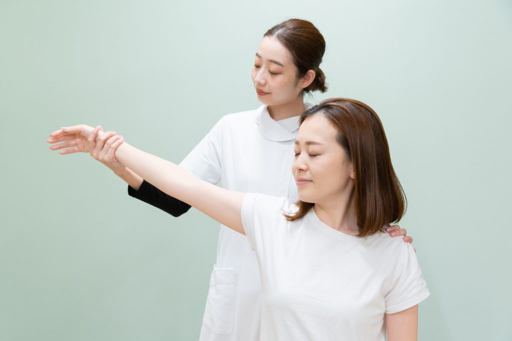 Physiotherapist conducting frozen shoulder range of motion exercise.