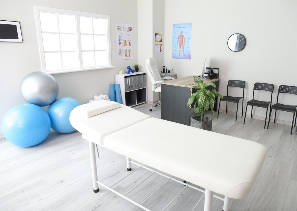 image shows a possible physical therapy clinic with a small office, a treatment table and essential equipment for therapy. 