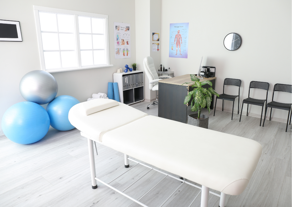 Physical therapy clinic image shows a possible physical therapy clinic with a small office, a treatment table and essential equipment for therapy.