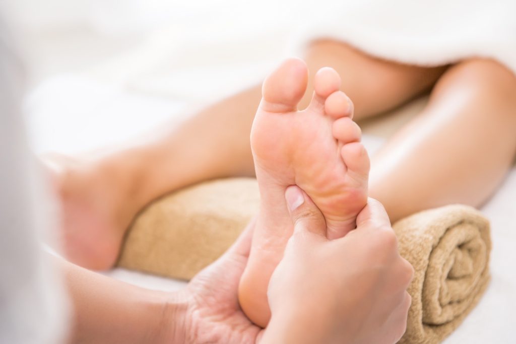 Image shows foot being massaged.