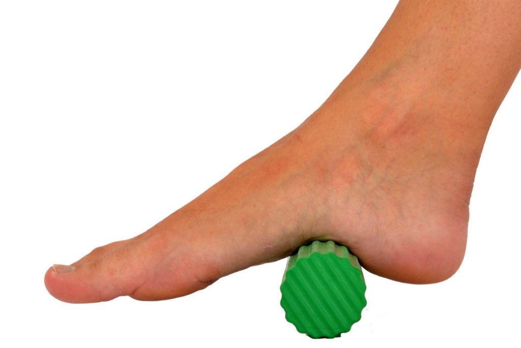 Image shows rolling foot over using a green foot roller.