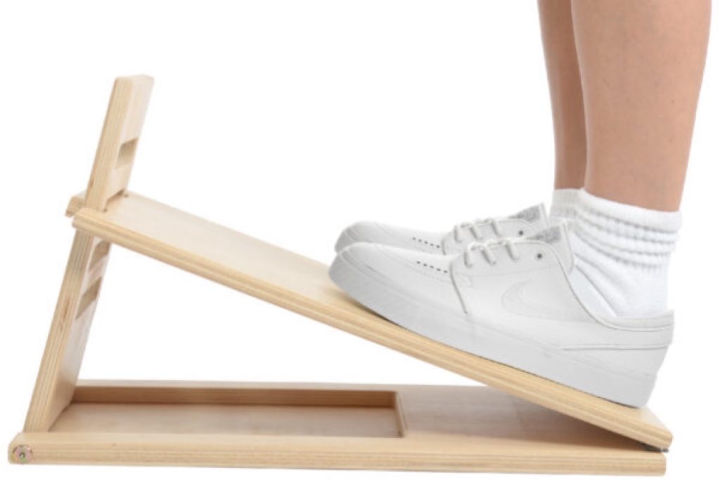 Image shows an incline board used for stretching the calves.