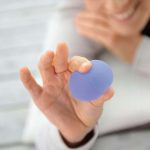 Image of a lavender Sissel Press Ball being pressed by a person