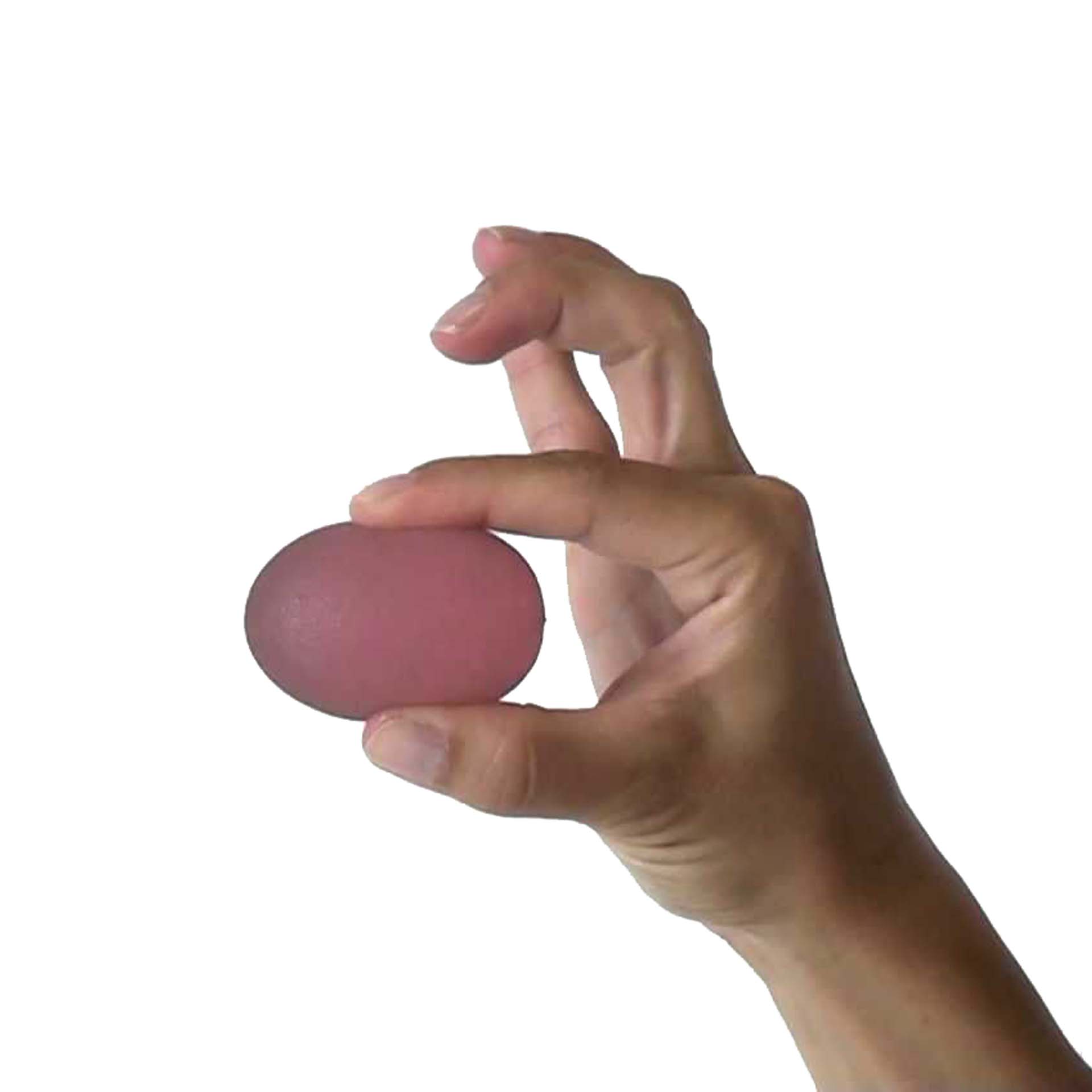 Image of a pink Sissel Press Egg being pressed by someone's hand