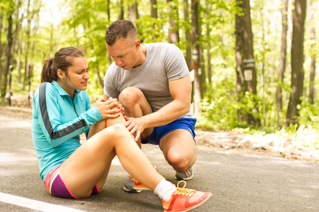 image shows woman having possible knee injury while jogging