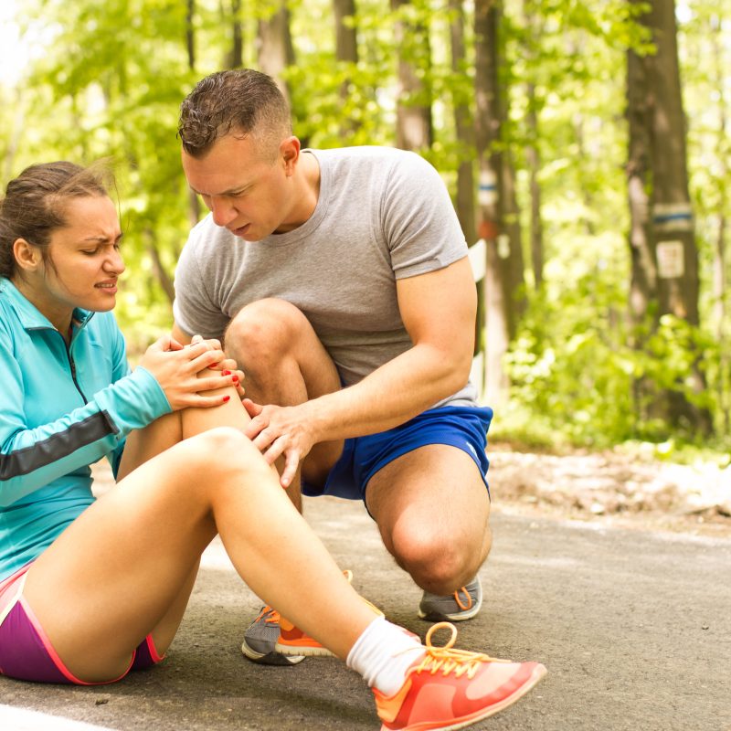 image shows woman having possible knee injury while jogging