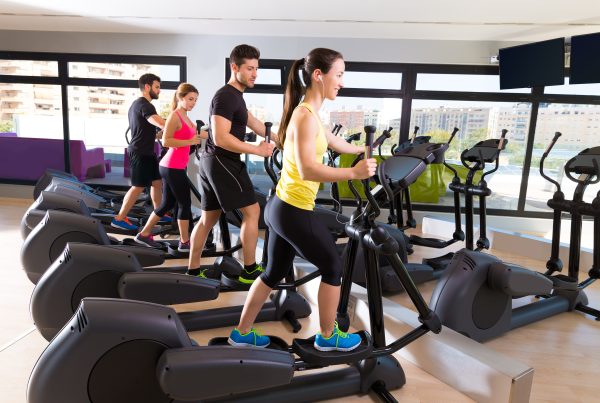 Low-impact cardio exercise on a trainer elliptical at the gym.