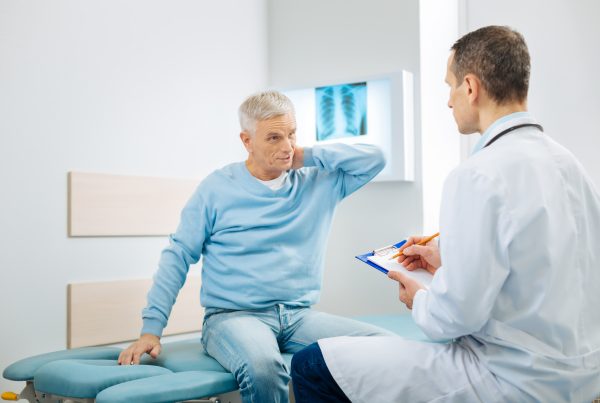 Elderly man consulting with his doctor.
