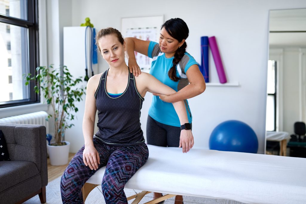 Physiotherapist giving treatment to patient.