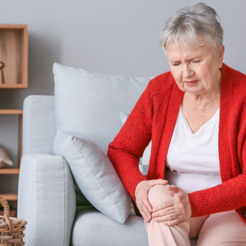 Senior woman suffering from knee pain possibly because of knee osteoarthritis.