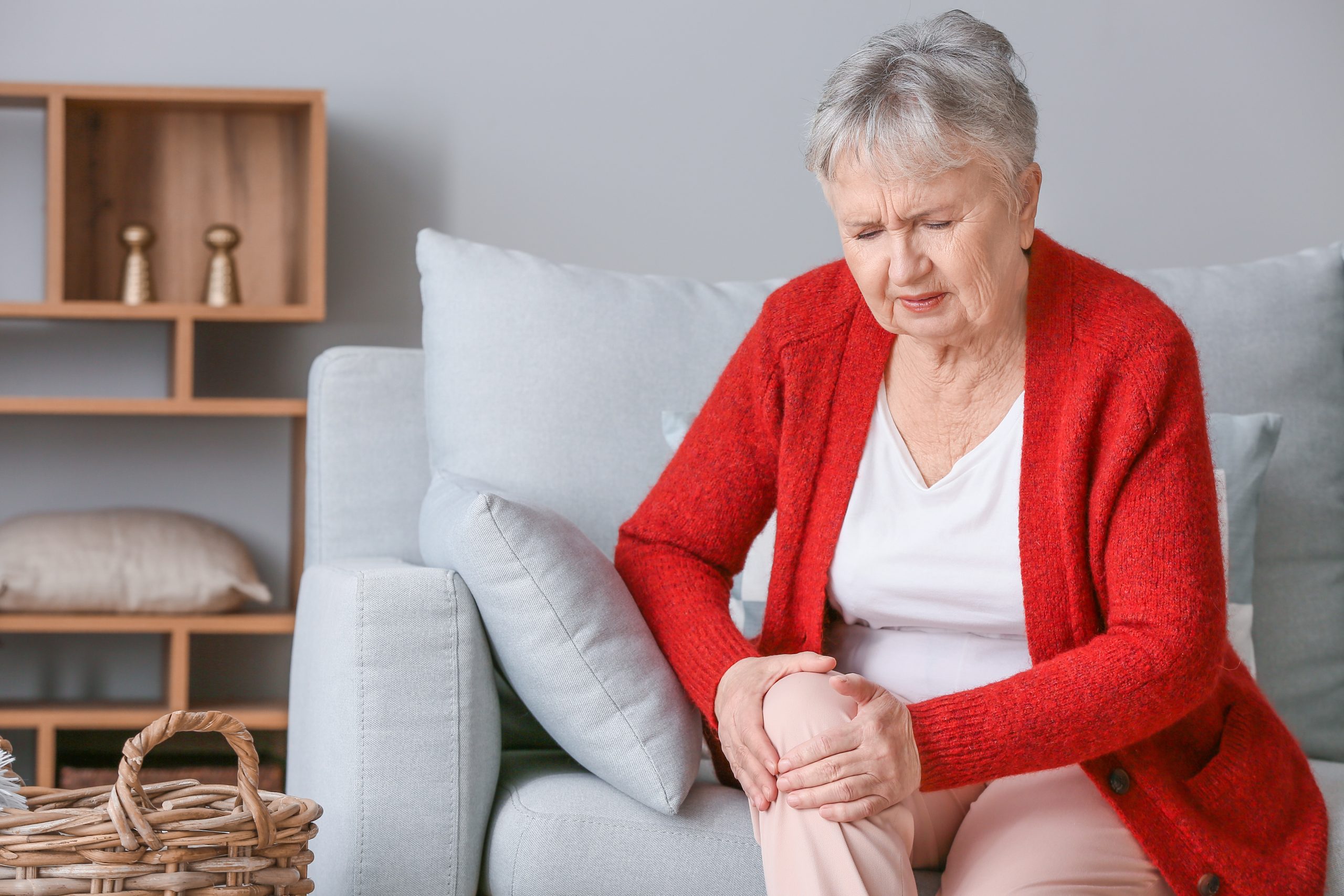 Senior woman suffering from knee pain possibly because of knee osteoarthritis.