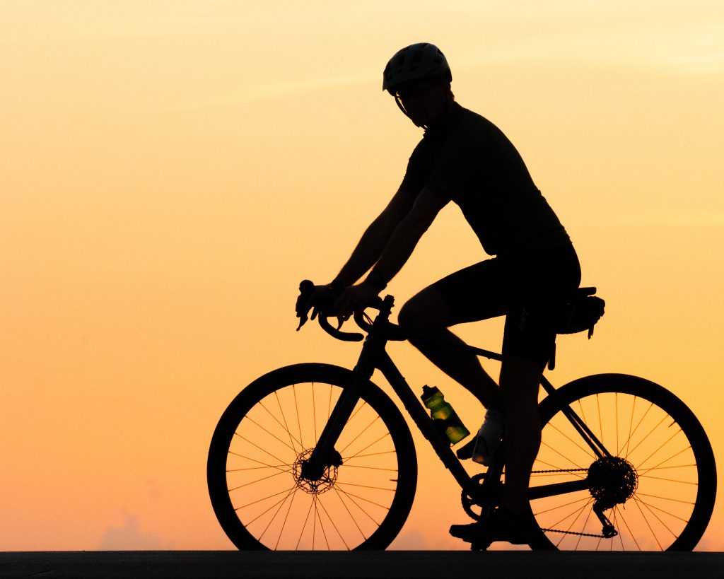 Silhouette of a man going cycling.