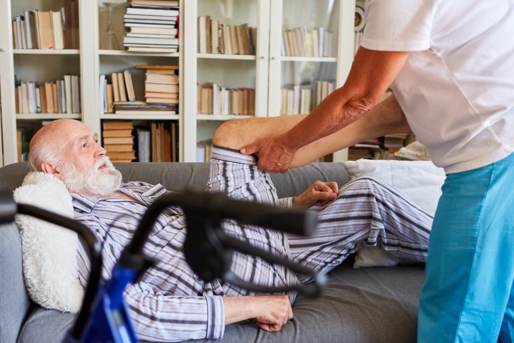 Senior man receiving physical therapy for his knee.