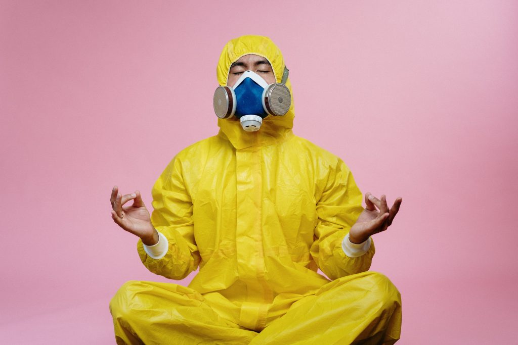 Man on a PPE with his mask on.