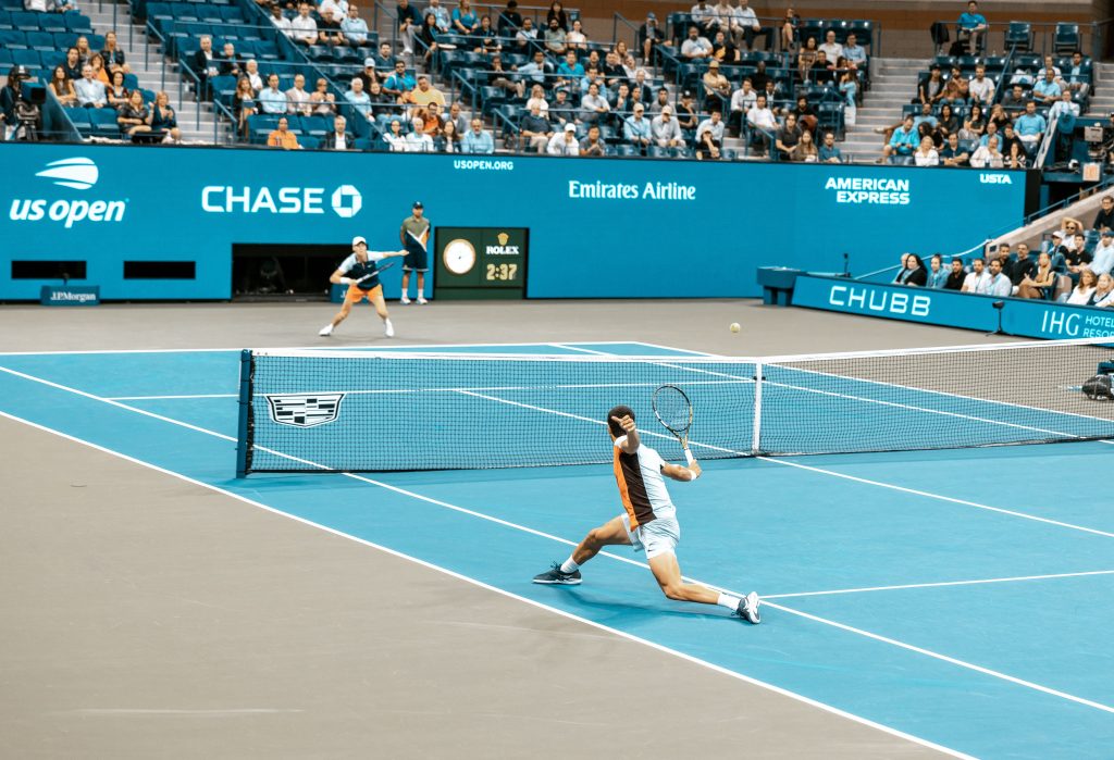 Athletes playing tennis which is a form of high-intensity cardio exercise.
