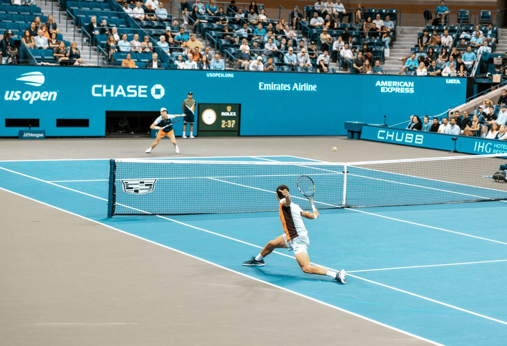 Athletes playing tennis which is a form of high-intensity cardio exercise.