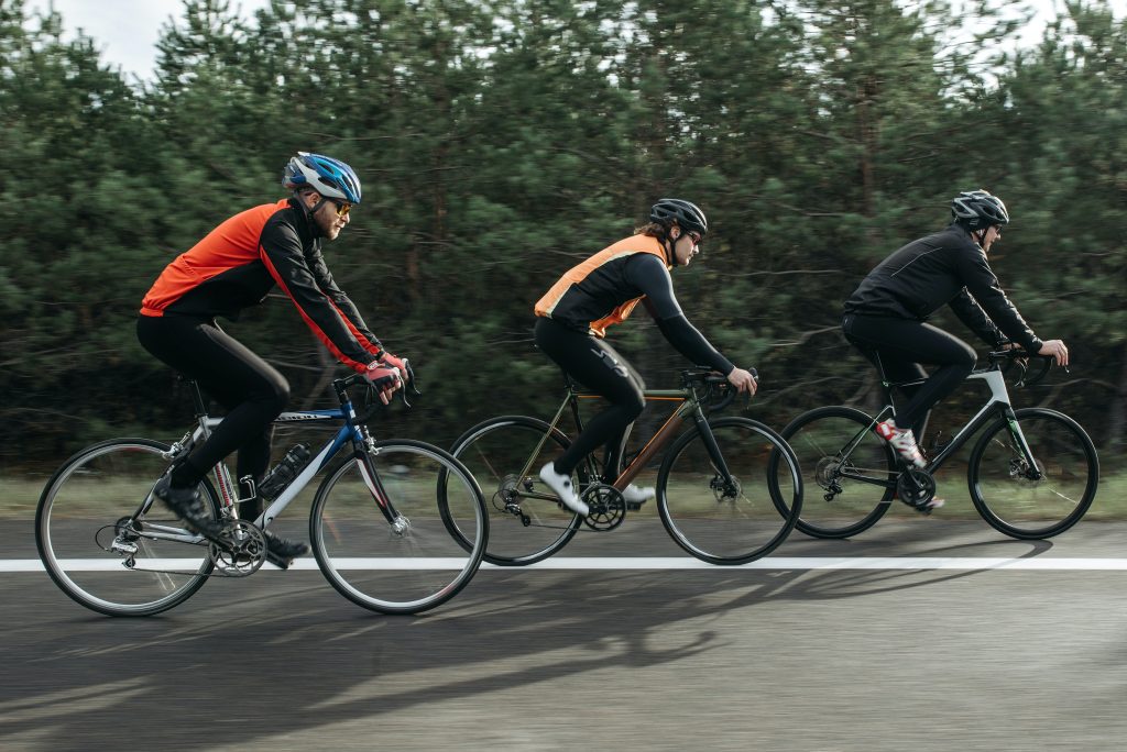 Group of people cycling outdoors.