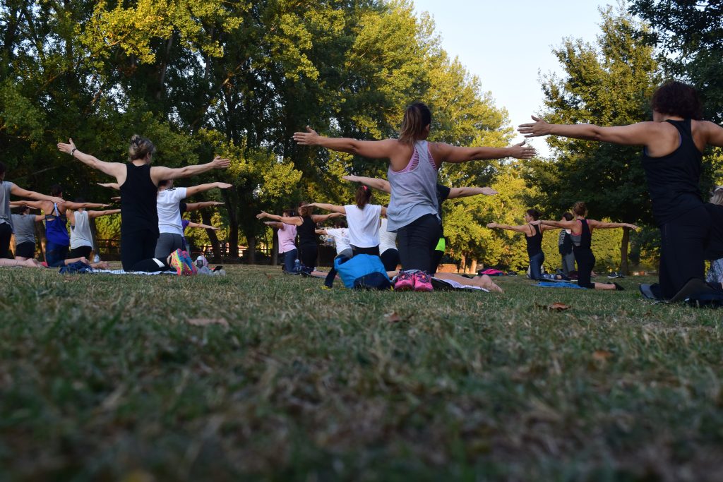 Group of people enjoying outdoor pilates.