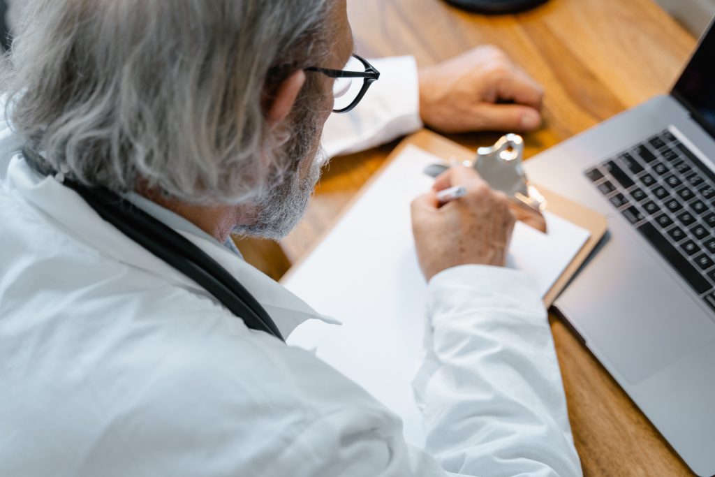 Physiotherapist writes down questions to get referrals