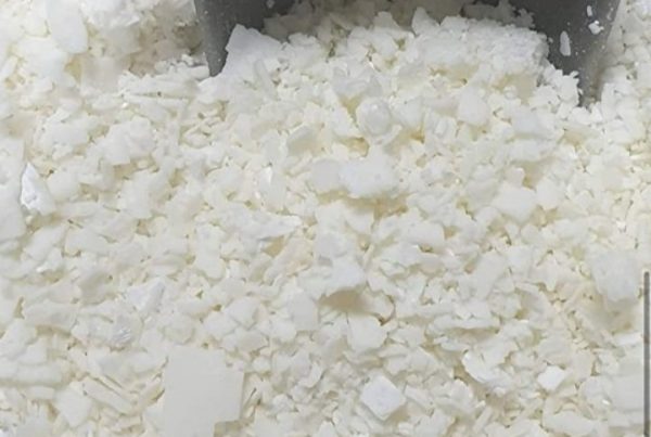 Image of small white pellets of paraffin wax, Paraffin wax is a commonly used product in physiotherapy for its therapeutic benefits.