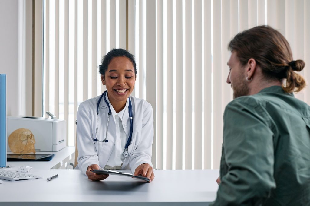 a physiotherapist talking to a current client