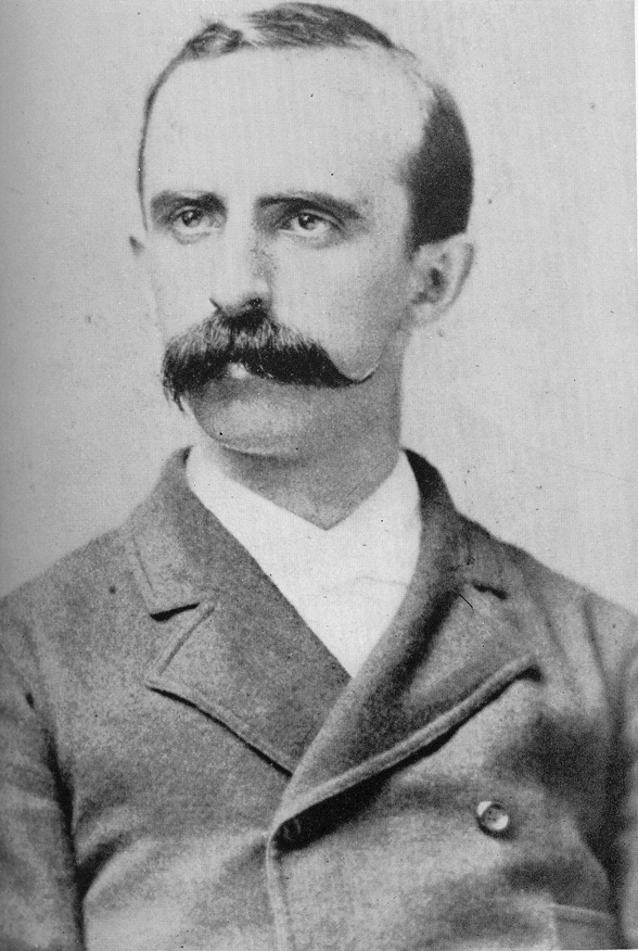 a black-and-white photo of Dr. Virgil Gibney, posing for his portrait