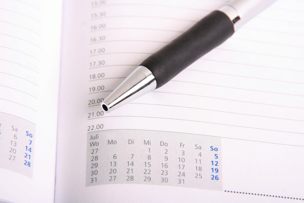 a pen on an open calendar page