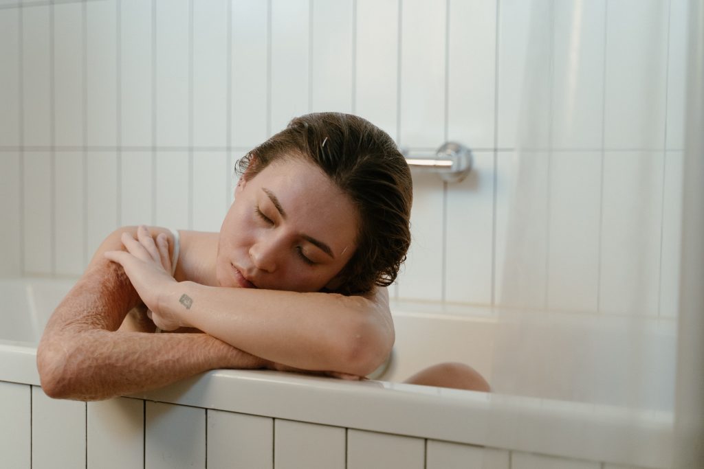 A lady is already falling asleep while taking her Epsom salt bath