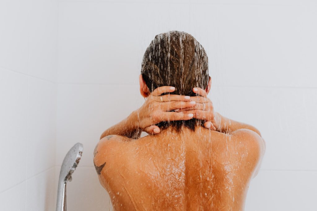 A person is using Epsom salt in the shower in their Epsom salt steam shower