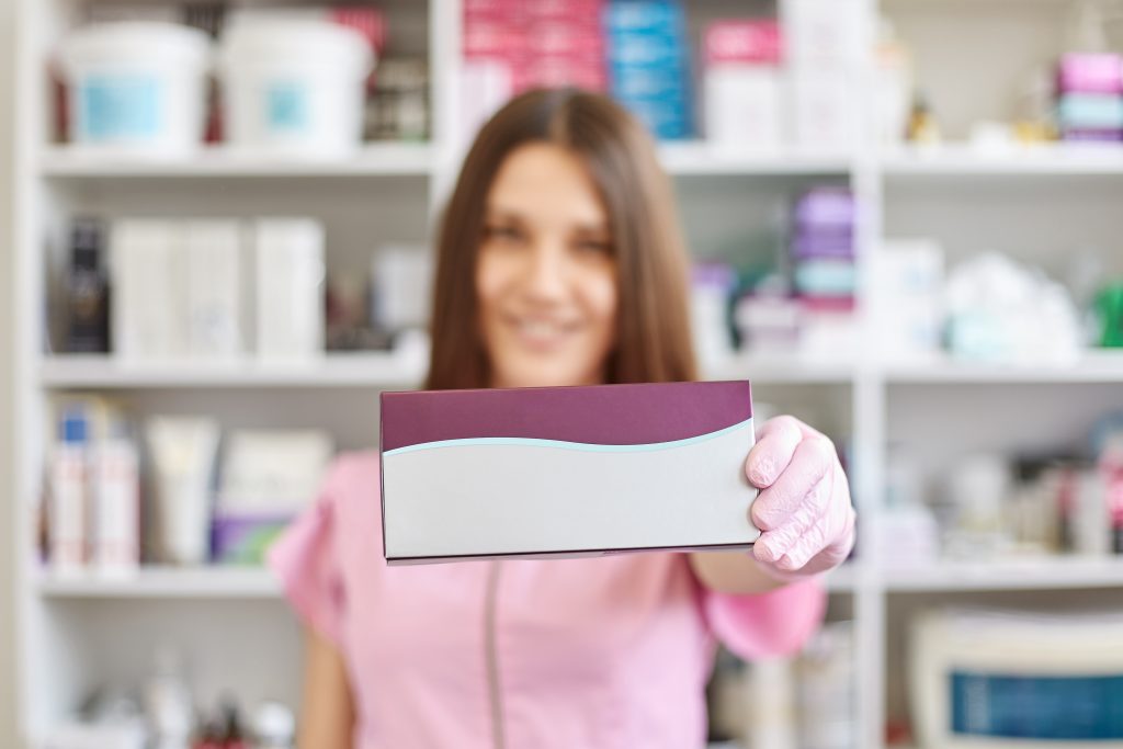 A physiotherapist is showing one of the clinic's patients a product the clinic offers alongside others in their limited inventory