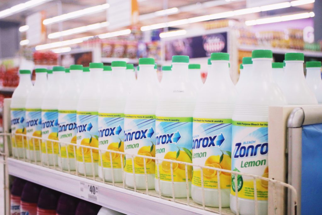 Bottles of lemon-scented bleach on a rack in a supermarket