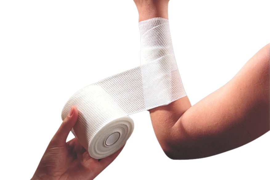 A person is using white cohesive bandage to wrap the arm of another person while in front of a white background