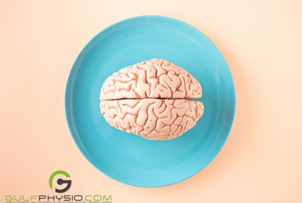 A model of the human brain served on a blue plate with a pink background.