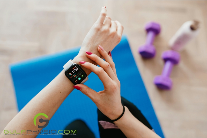 A close-up of a smartwatch on a person's wrist. They appear to be tracking their workouts.