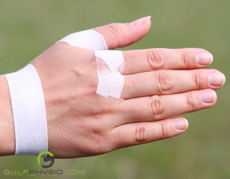 A hand wrapped in translucent medical tape.