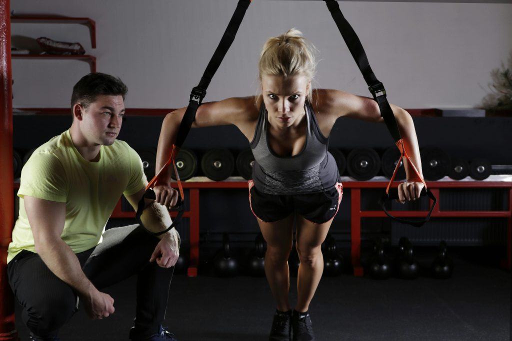 A woman working out with her trainer