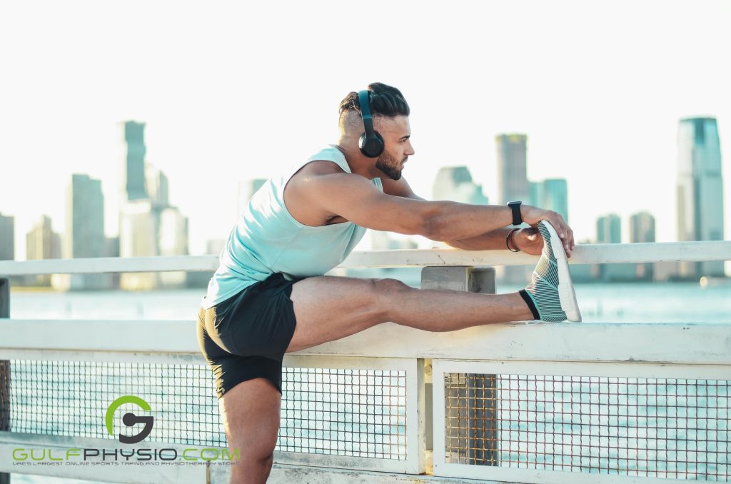A man stretching his leg before a workout.