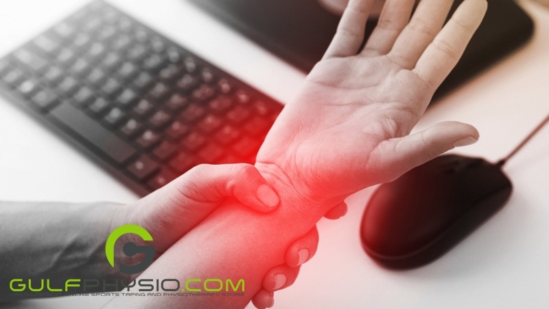 A close-up photo of a pair of hands. The left hand is clutching the right wrist, highlighted by a red hue to indicate pain.